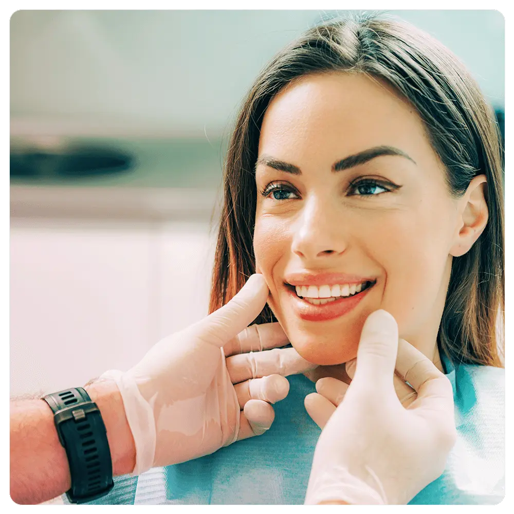 Patient smiling with dentist's hands