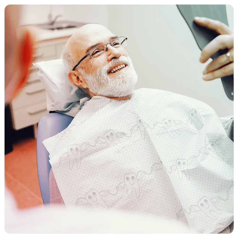 Patient smiling looking at himself in the mirror