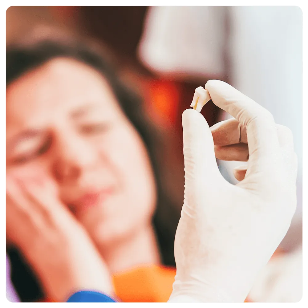 Tooth extraction with patient in the background