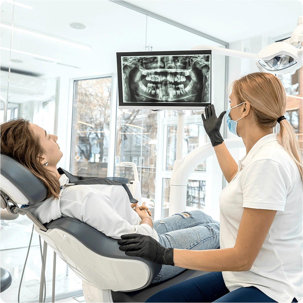 dentist showing screen to patient