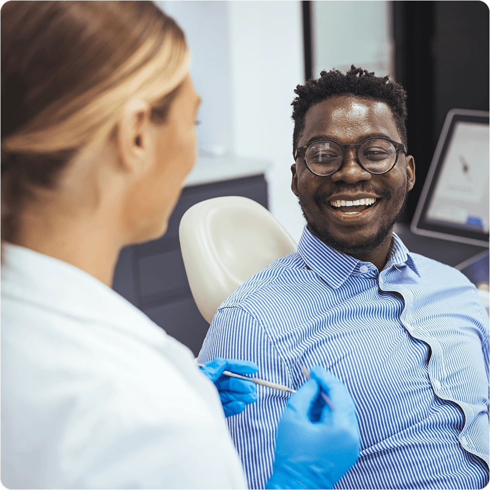 Dentist talking to patient smiling